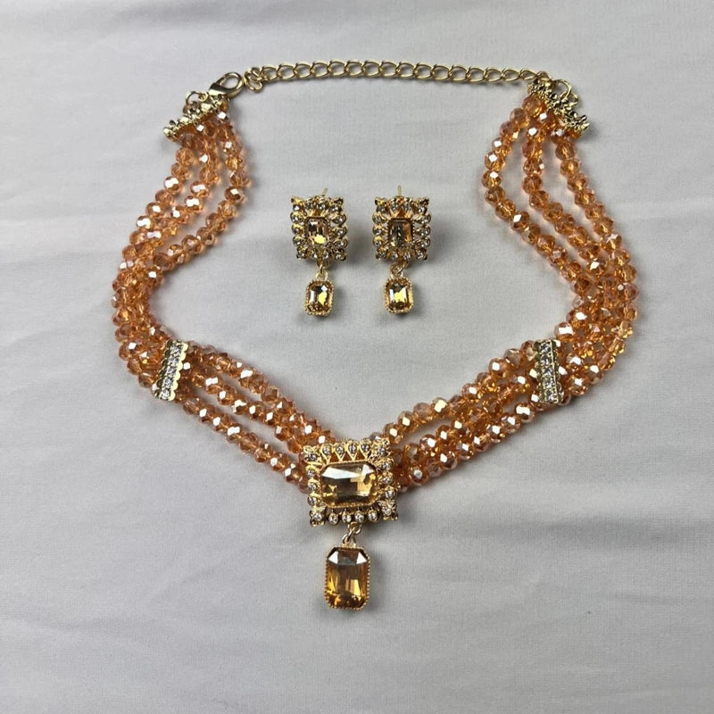 Parure ras de cou dorée avec cristaux champagne et boucles d’oreilles assorties pour mariage oriental
